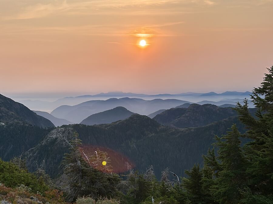 Sunset views from near the summit of 5040 Peak, with layers of mountains fading into the distance